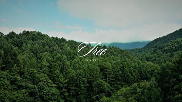 Green forested hills beneath a pale blue sky, with white Tree Wall Art lettering.