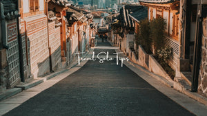 Solo travel photographer walking alone through an urban street capturing real moments and authentic experiences