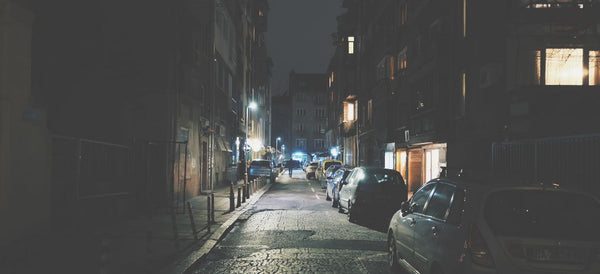 Night street photography of an illuminated city street after dark