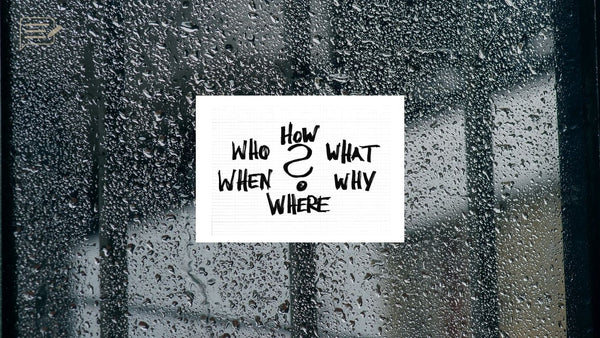 Who, what, when, where, why, and how graphic on a rain-covered window, representing the questions behind what makes a good photograph