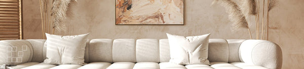 Boho wall art above an ivory sofa with pampas grass