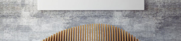 Large wall art display with a white canvas above a curved wooden chair