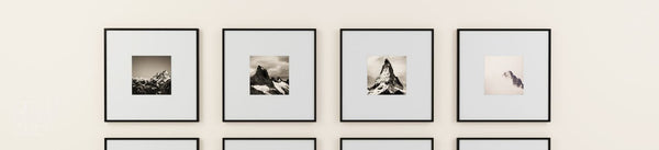 Square wall art collection banner showing framed mountain photographs on a cream wall