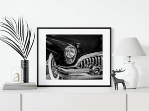 Whitewall tyre beside the polished front bumper of a vintage Buick