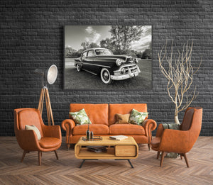 Monochrome classic Chevrolet with reflective windows and sweeping chrome bumper