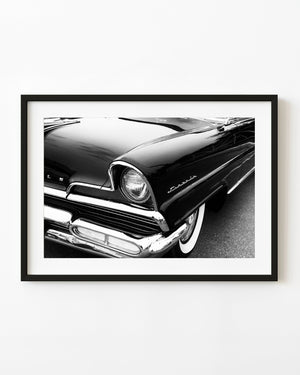 1956 Lincoln Capri front corner with round headlight and chrome bumper in black and white