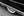 Whitewall wheel partly hidden beneath dark Lincoln Capri bodywork and chrome trim