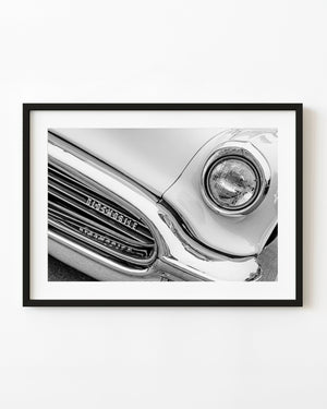 1956 Oldsmobile Super 88 headlight and curved chrome grille in black and white