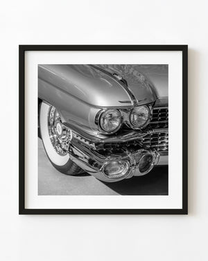 1959 Cadillac twin headlights and chrome bumper in black and white