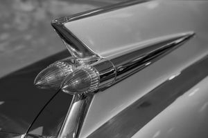Pointed Cadillac taillight lenses beneath a sharp fin and long chrome trim