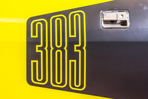 Iconic yellow “383” decal on a classic muscle car