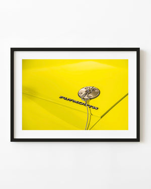 1971 Plymouth Cuda yellow hood with metal lettering and a chrome hood pin