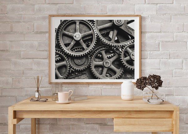 Panoramic view of an array of vintage gears, portraying the scale and depth of historical machinery used during the industrial revolution.