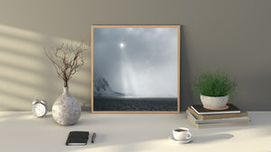 Soft polar light and snowy coastal mountains beneath an overcast sky.