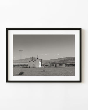 Abandoned church in Amboy, California, beneath an open desert sky, photographed in black and white.