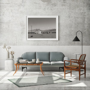 A quiet California desert church with gravel foreground and mountain ridges.