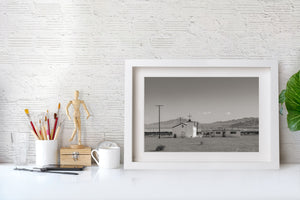 Route 66 church photograph with pale architecture, utility poles and open desert.