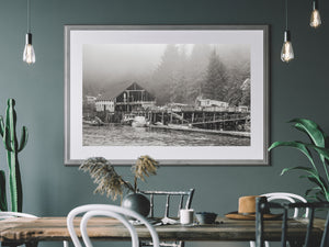 British Columbia resort photograph showing weathered timber structures along a quiet shore.