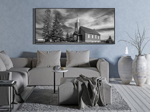 Monochrome prairie church photograph with a pitched roof and narrow steeple.