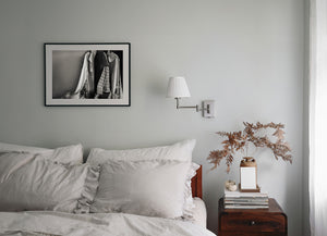 Monochrome photograph of hanging fabric and household objects in a Bahamas interior.