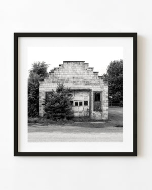 Abandoned garage in South Whitley, Indiana, with a stepped facade in black and white.