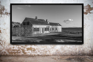 Black and white photograph of an abandoned Maine waterfront house
