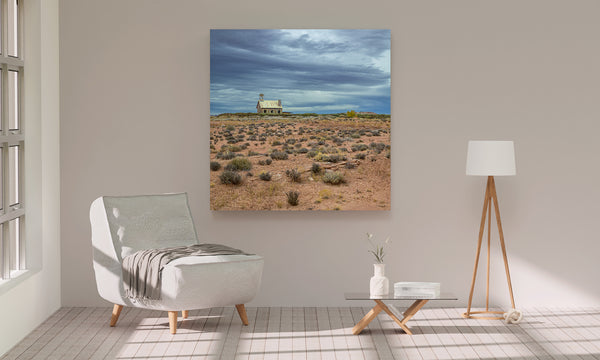 Weathered schoolhouse beneath stormy sky