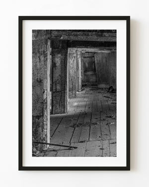 Abandoned Ontario factory interior with repeating concrete openings in black and white