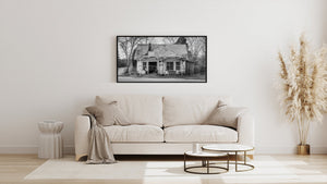Bare branches surround an abandoned house beside a curving rural road
