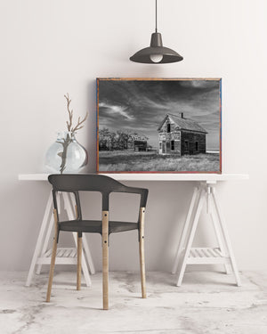 Black and white photograph of two deserted Saskatchewan farm buildings