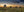Panoramic photograph of a deserted prairie farmstead at sunset in Saskatchewan.