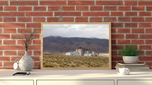 Pale towers and low roofs of a deserted soda ash plant in the eastern Sierra landscape.