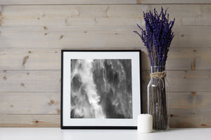 Bright bursts of water and grey veils of spray form an abstract waterfall pattern.