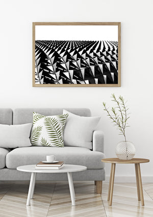 Black and white geometric architecture detail with repeated triangles and structural lines.