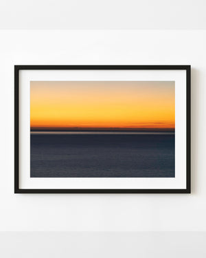 Golden dusk sky above a level Adriatic Sea horizon and dark blue water.