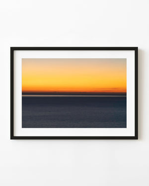 Golden dusk sky above a level Adriatic Sea horizon and dark blue water.