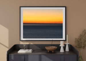 Warm evening colour fades upward above a quiet Adriatic Sea horizon.