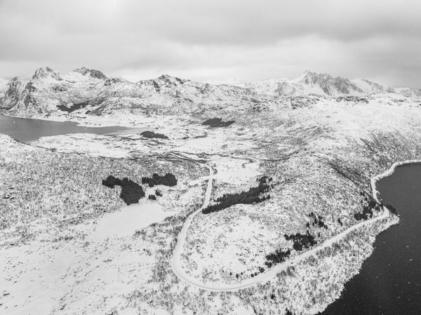 Snow-covered mountains and winding road in Norway