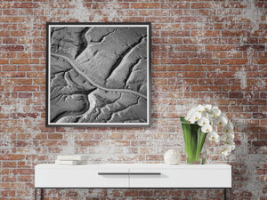 Abstract square Alaska landscape with curving waterways and varied grey coastal surfaces.