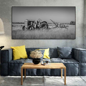 Old farm machinery forms a low band across an open Alberta field beneath a broad sky.