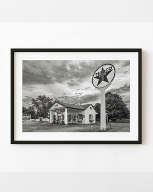 A tall Texaco sign stands beside Ambler’s station in Dwight, Illinois, in a black and white Route 66 photograph.
