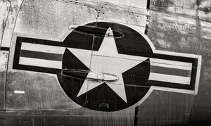 A light star inside a dark circle and horizontal bars fills the aircraft surface close-up.