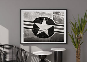 Protruding fittings interrupt the pale star painted over textured aircraft metal.