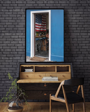 Red, white and blue repeat in the flag and doorway around a small back-room scene.