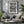 Monochrome Grand Central photograph with draped flag fabric, stone walls and a hanging chandelier.