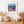 Colour memorial photograph with flag fabric, wooden rails and an open mountain landscape.