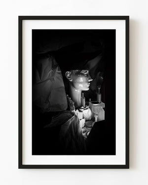 Black and white Amsterdam still life with a mannequin profile catching light in shadow.