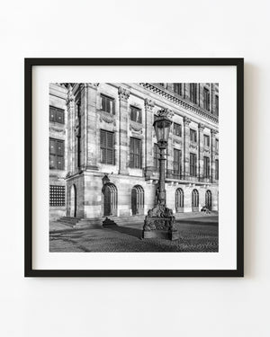 Amsterdam Royal Palace and an ornate streetlamp photographed in black and white.