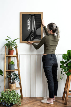 Arched window panes and curving staircase rails in a quiet Amsterdam building.