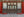 Symmetrical Chinese doors framed by red palace walls